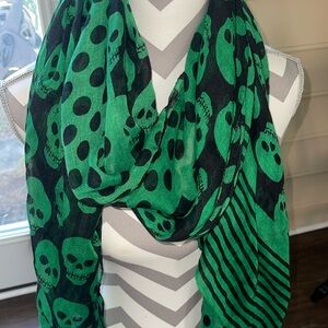 Green and black scarf with skull design